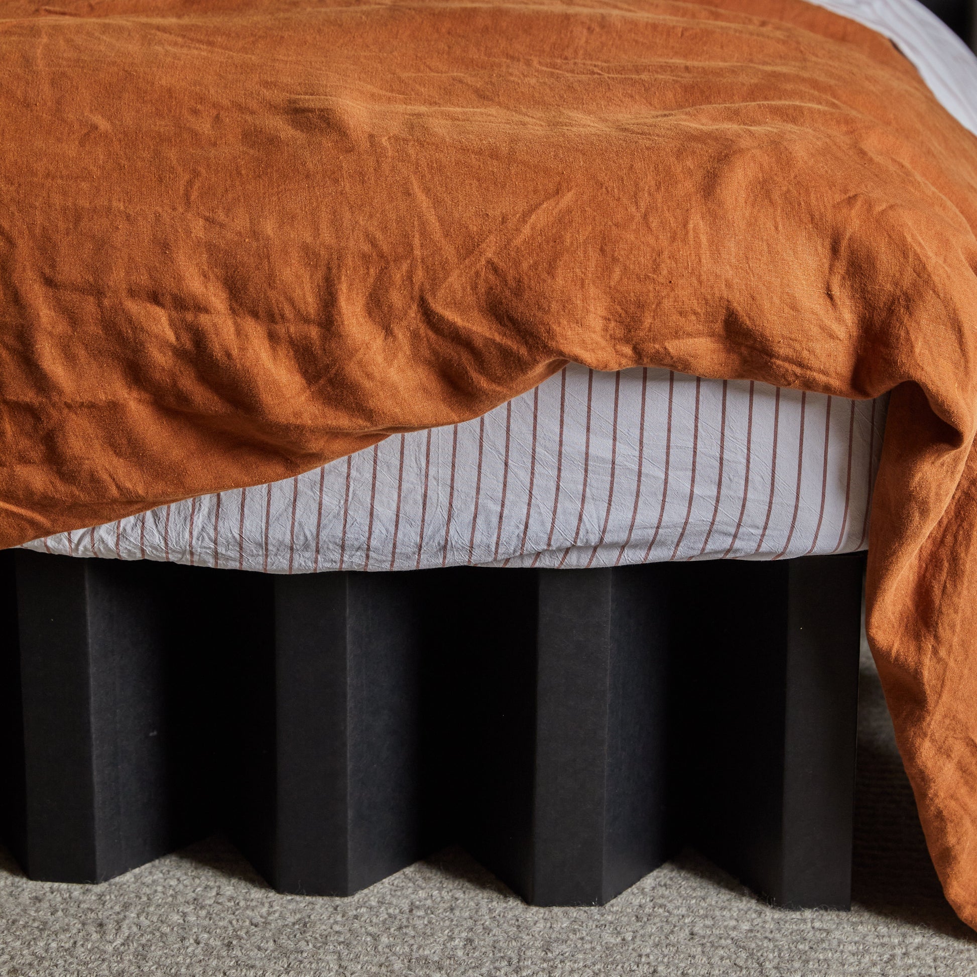 Close-up of Yona Cardboard Bed base in black finish