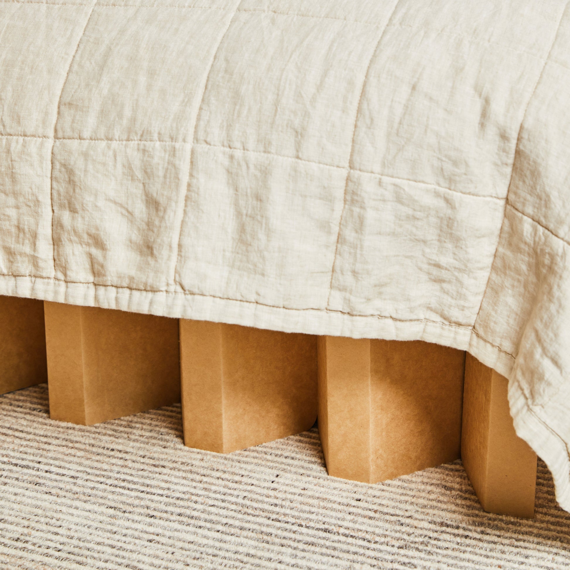 Image of a Yona Cardboard Bed with an angled close in a well-lit setting