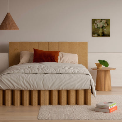 Yona Cardboard Bed in natural finish with rust accent pillow and wooden decor in a minimalist bedroom